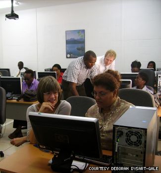 General Studies Unit professor Deborah Dysart-Gale (left foreground) explains the ENCS’ database and its practices to a social worker in the St. Kitts capital city of Basseterre in September. In background, left: National ICT Centre Director Chris Herbert with Daniel Sinnig, Concordia post-doctoral fellow.